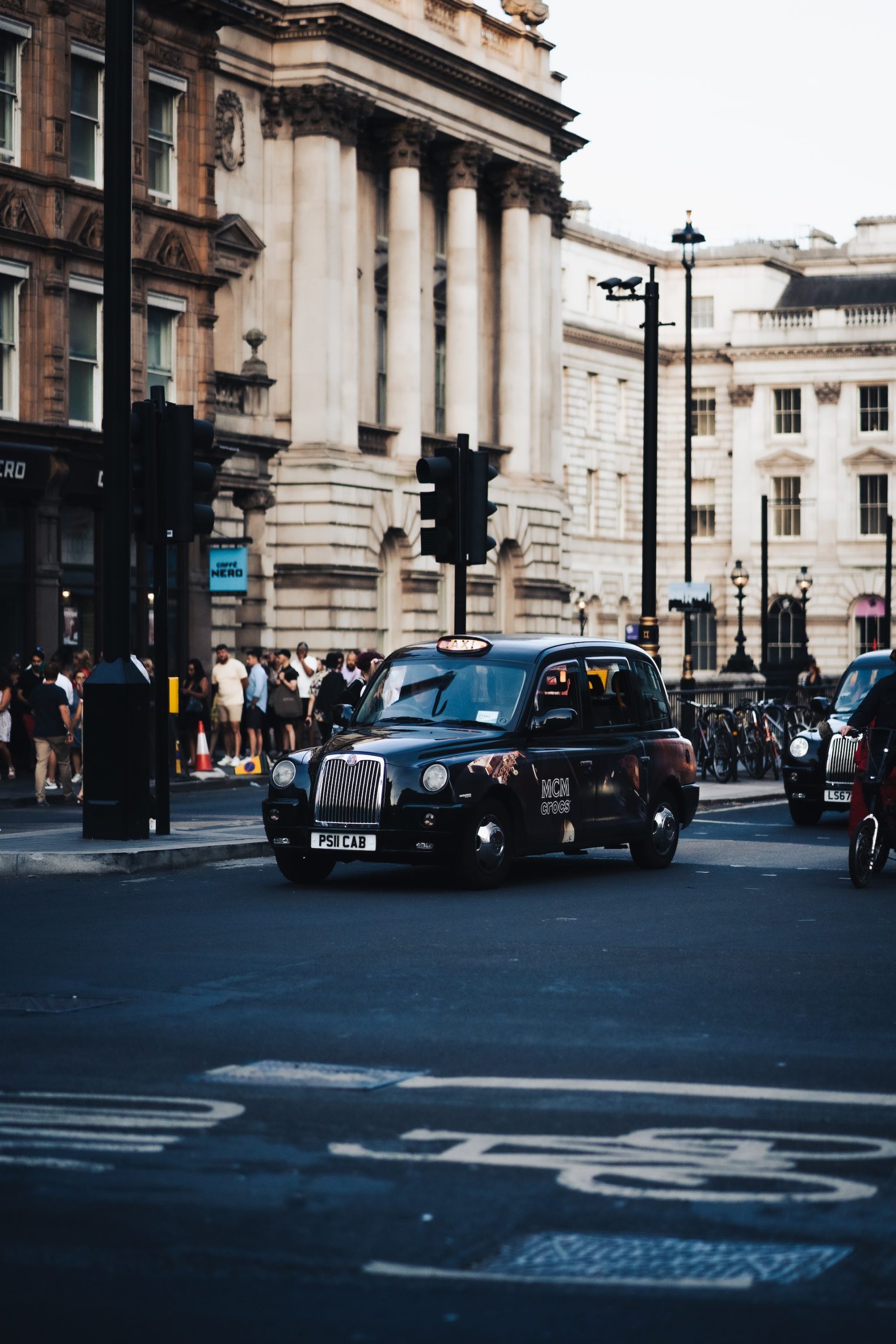 Image of London street with black London taxi in motion